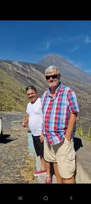 a man and a woman standing on a road at chez albino guest house in São Filipe