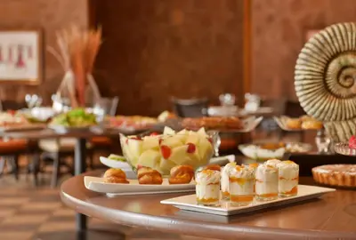 a buffet of food on a table in a restaurant at Pestana Tropico Ocean & City Hotel in Praia