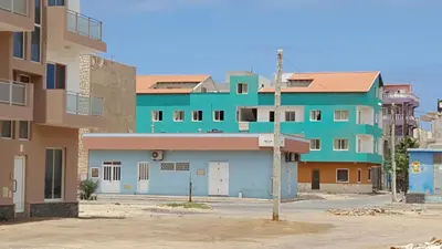 a row of apartment buildings in a city at OKEANOS in Sal Rei