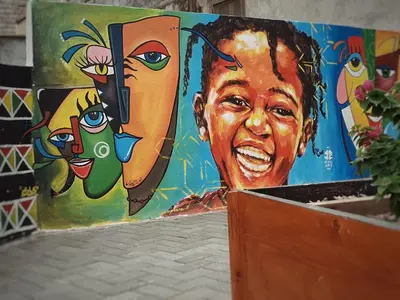 a wall with a painting of a woman on it at Casa Sodadi in Praia