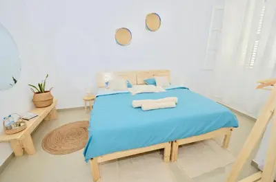 a bedroom with a blue bed with two pillows at Casa Sodadi in Praia