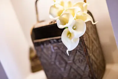 a vase with a white flower in it at Angulo House in Santa Maria