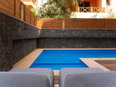 a swimming pool with blue water in a backyard at Angulo House in Santa Maria