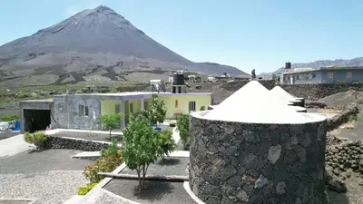 a mountain in the background with houses and a building at Casa helena in Portela