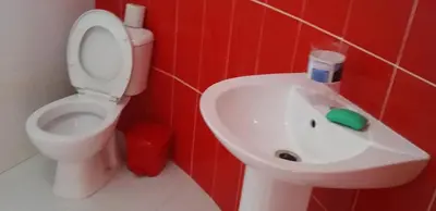 a bathroom with a white sink and a toilet at Casa helena in Portela