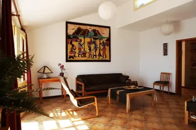 a living room with a couch and a table at XXL Apt w/ Surprising Gorgeous Ocean View in Praia