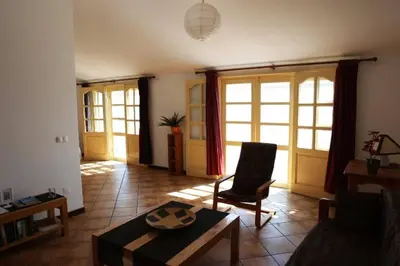 a living room with a table and a chair at XXL Apt w/ Surprising Gorgeous Ocean View in Praia