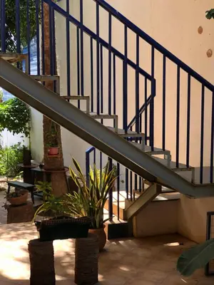 a metal staircase with a potted plant next to it at XXL Apt w/ Surprising Gorgeous Ocean View in Praia