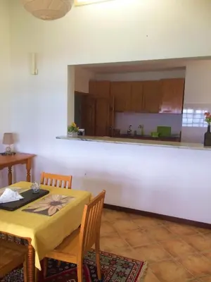 a kitchen and dining room with a table and chairs at XXL Apt w/ Surprising Gorgeous Ocean View in Praia