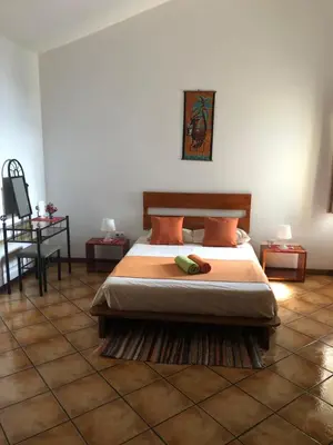 a bedroom with a bed and a tiled floor at Couple Getaway with Panoramic Ocean View in Praia
