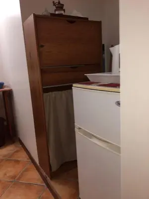 a kitchen with a white refrigerator and a dresser at Splendid Guest Suite with Separate Private Ocean View Terrace in Praia