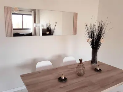 a dining room table with a vase on top of it at Apartment with pool in Mindelo in Mindelo