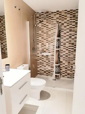 a bathroom with a toilet and a shower at Apartment with pool in Mindelo in Mindelo