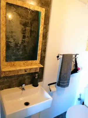 a bathroom with a white sink and a toilet at Casa Blu Guesthouse - Casa de Hospedes in Santa Maria