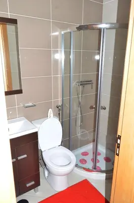 a bathroom with a shower with a toilet and a sink at Domingas in Praia
