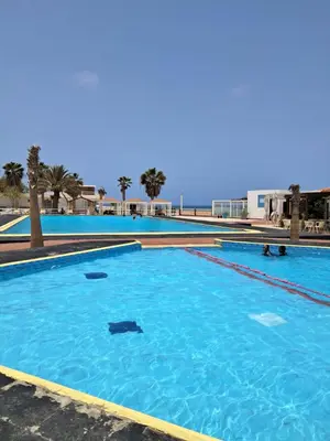 a large swimming pool with blue water at Vivenda Ronnie in Beirona