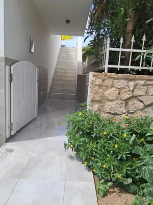 a staircase leading to a building with yellow flowers at Vivenda Ronnie in Beirona