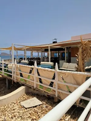 a house with chairs and a fence in front of it at Vivenda Ronnie in Beirona