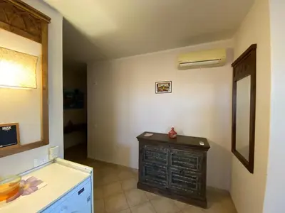 a kitchen with a dresser in the corner of a room at Zen House Tropical in Santa Maria