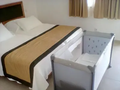 a bedroom with a bed and a baby crib at Mister Barracuda in Santa Maria