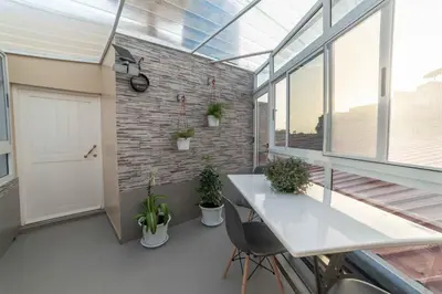 a room with a white table and some plants at A Casa da Mizi in Praia