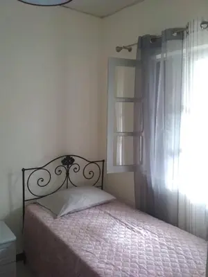 a bedroom with a bed and a window at Casa Pedrina in Ribeira Grande