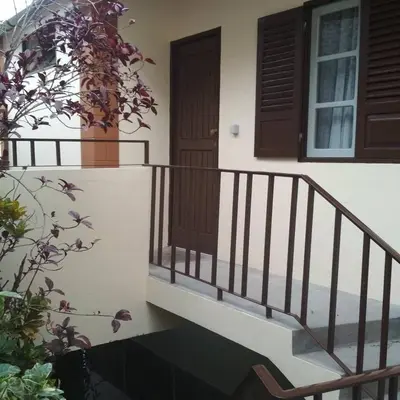 a staircase leading to a house with a door at Casa Pedrina in Ribeira Grande