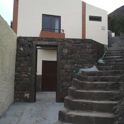 a stone stairway leading to a building with a door at Casa Pedrina in Ribeira Grande