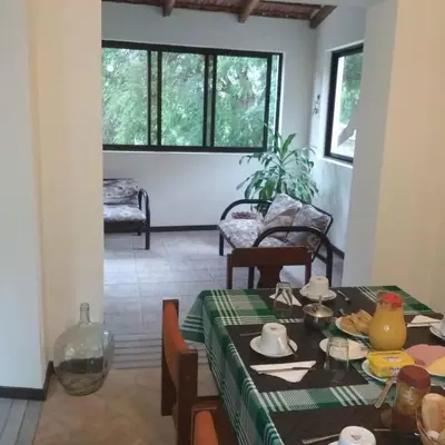 a dining room with a table with a green table cloth at Casa Pedrina in Ribeira Grande