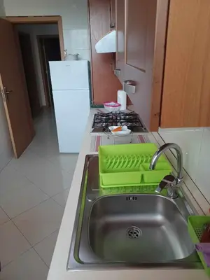 a kitchen with a sink with a green tray on it at Secularis Capital in Praia