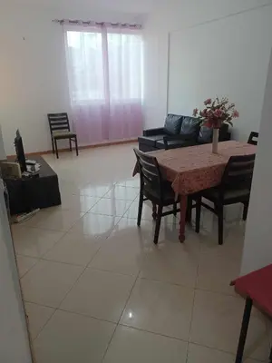 a living room with a table and chairs and a couch at Secularis Capital in Praia