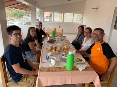 a group of people sitting around a table at Residencial Pôr do Sol in Porto Novo