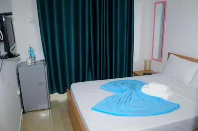 a bedroom with a bed with a blue blanket on it at Plateau Bedroom & Chambre - Praia Center 1 in Praia