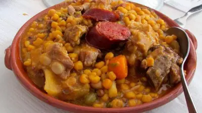 a red bowl of food with meat and beans at Hotel Avenida in Assomada