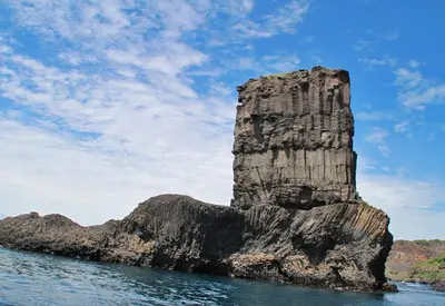 a rock island in the water with a blue sky at Hotel Avenida in Assomada