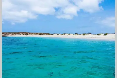 a beach with turquoise water and a white beach at Kasa Mona in Calheta Do Maio
