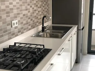 a kitchen with a sink and a stove at Harmony apartment in Mindelo São Vicente in Mindelo