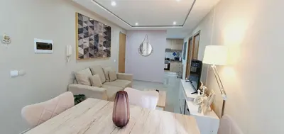 a living room with a vase on a wooden table at kelly's House Plateau City Center in Praia