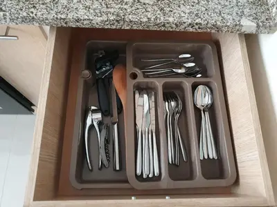 a tray of utensils sitting in a drawer at kelly's House Plateau City Center in Praia