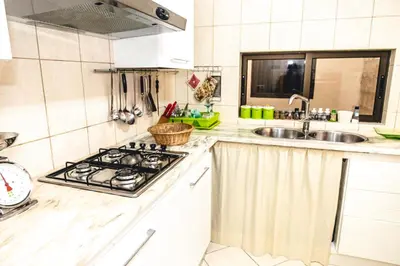 a kitchen with a stove and a sink at Criola Vistamar in Mindelo
