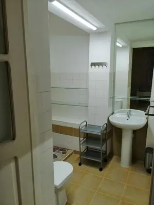 a bathroom with a sink and a toilet and a mirror at Casas do Cinema I in Mindelo