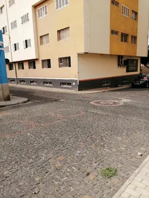 an empty street in front of a building at Casas do Cinema I in Mindelo