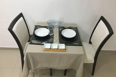a table with two plates and a glass bowl on it at Studio GARAGE in Mindelo