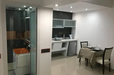 a kitchen and dining room with a table and a sink at Studio GARAGE in Mindelo