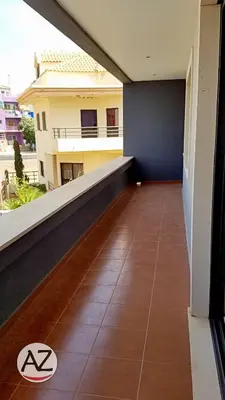 a balcony of a building with a tile floor at YOUR HOME AWAY FROM HOME in Praia