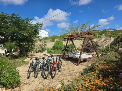 a group of bikes parked next to a gazebo at Casa Djarmai Apartments in Vila do Maio