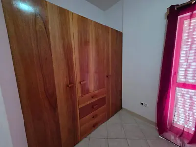 a room with a wooden door and a window at Casa Djarmai Apartments in Vila do Maio