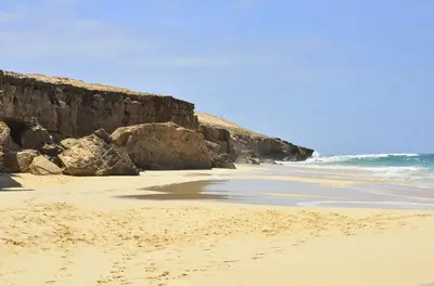 a sandy beach with rocks and the ocean at Ca' Santa Barbara, Free Wi-fi, Sea view, Sal Rei, Boa Vista, Cape Verde in Sal Rei