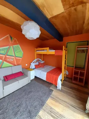 a kids room with a bunk bed and a couch at THE RETREAT in Monte Joana