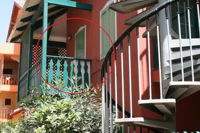 a red circle is on the side of a house at Ibiscus in Santa Maria
